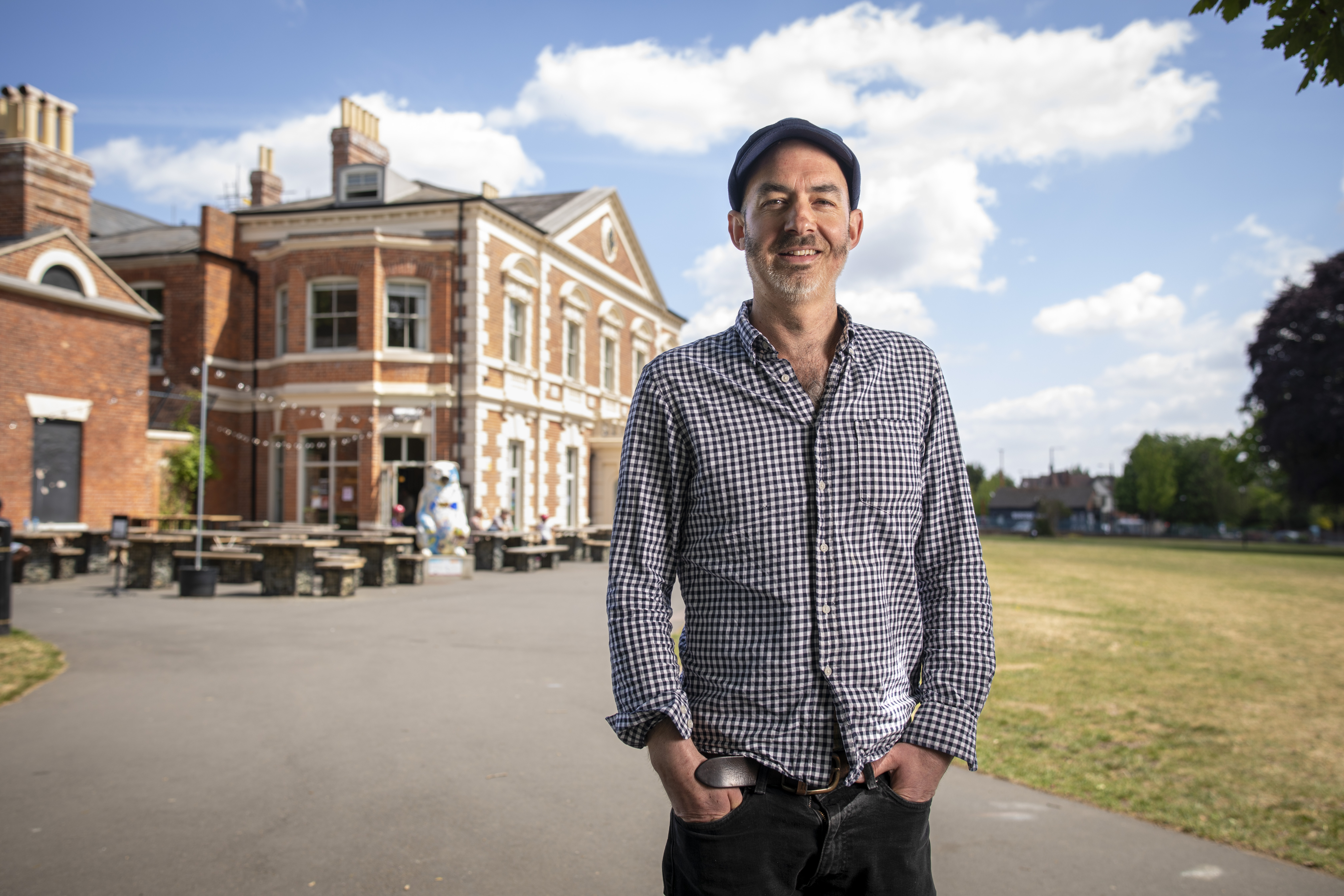 John Stapleton, co-founder of 1000 Trades, standing outside his pub, tearoom, and kitchen in Birmingham's Bearwood Park.